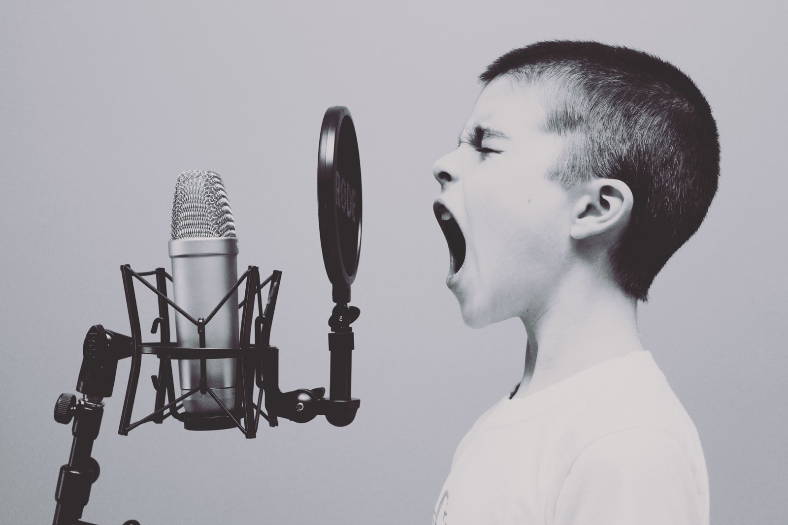 Frequently asked questions about book publicity. A child screaming into a microphone to convey the different ways to publicize your book.
