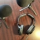 Headphones and microphones on a desk for a radio interview with indie authors who know what is the best way to promote a book during an interview.