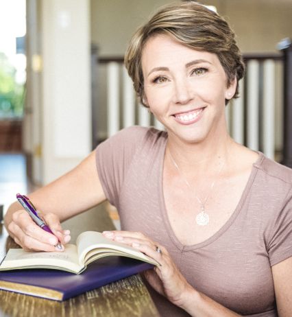 A beautiful women writing on notebook. Smith book publicity and author promotion services.