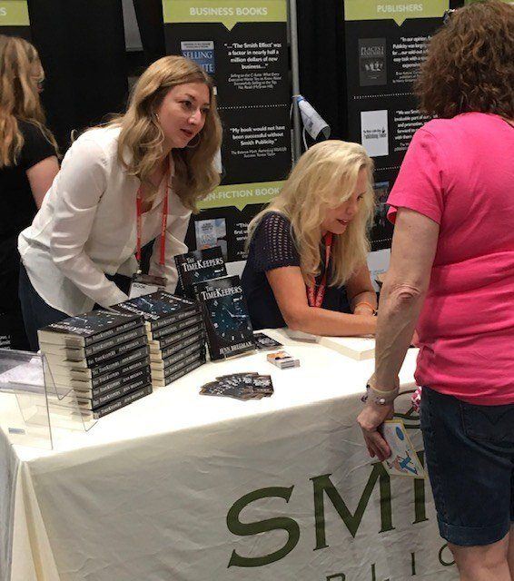 Sarah Miniaci managing client book signing, BookExpo 2018. Smith Publicity client author at a book signing event at bookexpo.